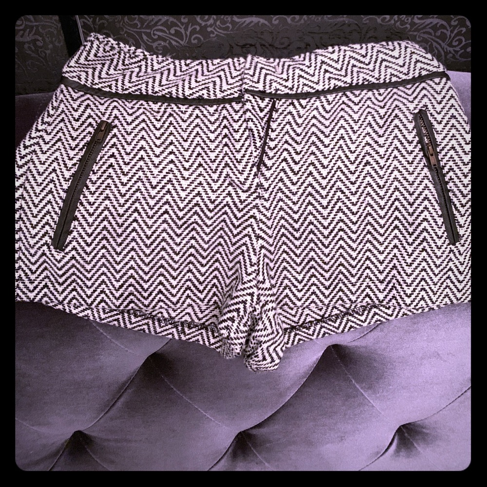 Black and white designer shorts trimmed in leather